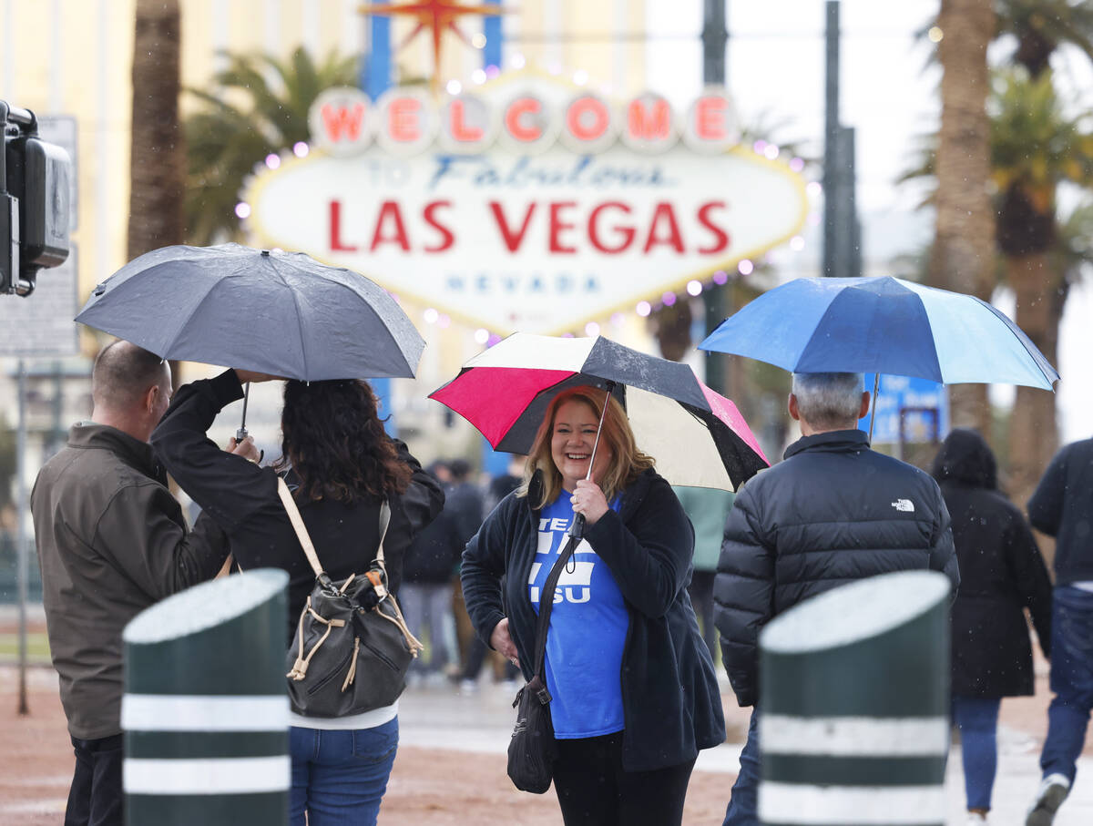 Tourists, including Kristine Tellers of Sebeka, Minnesota, center, line up to pose for a photo ...