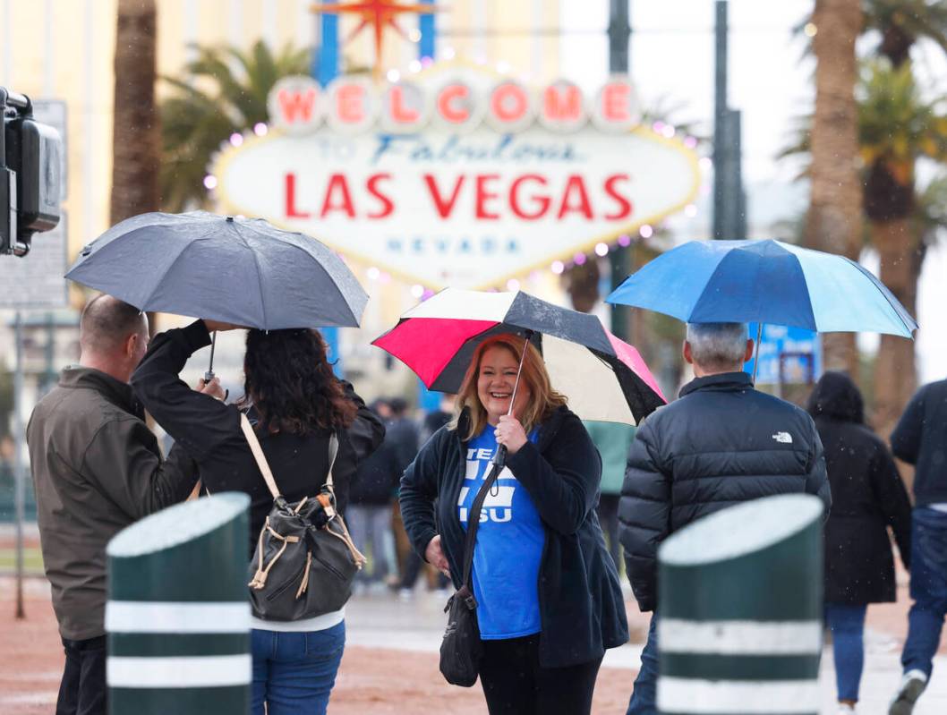 Tourists, including Kristine Tellers of Sebeka, Minnesota, center, line up to pose for a photo ...