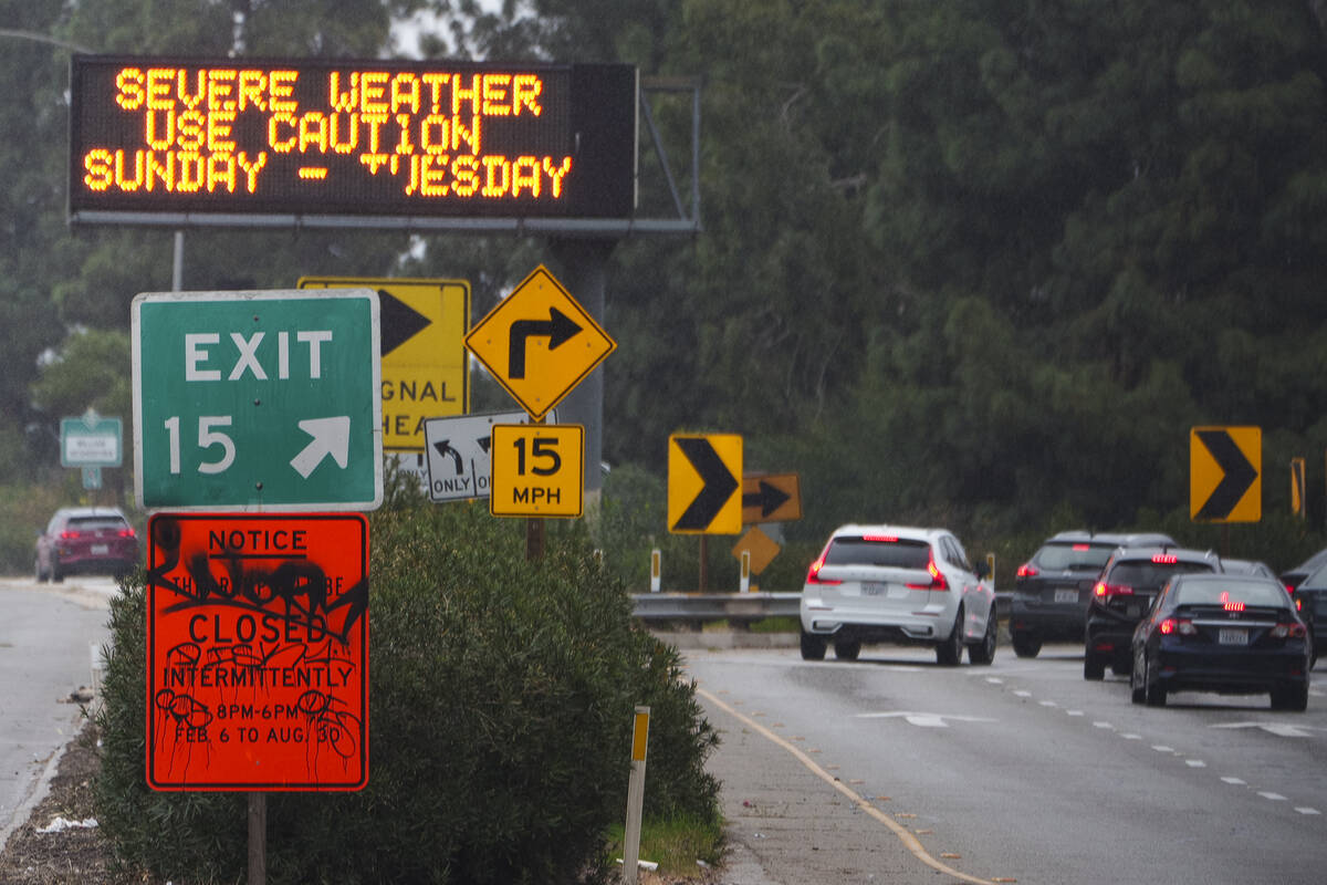 A sign warns motorists of severe weather on California State Route 2 (SR-2) in Los Angeles, Sun ...