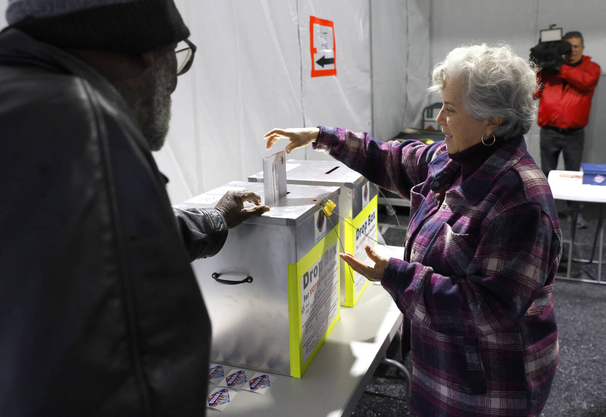 Martha Morris casts her ballot at a vote by mail dropbox during primary voting in Las Vegas Tue ...