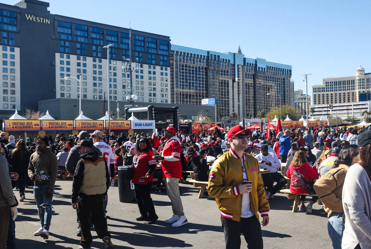 Crowds eat and order food at Guy’s Flavortown Tailgate party for Super Bowl LVIII at a p ...