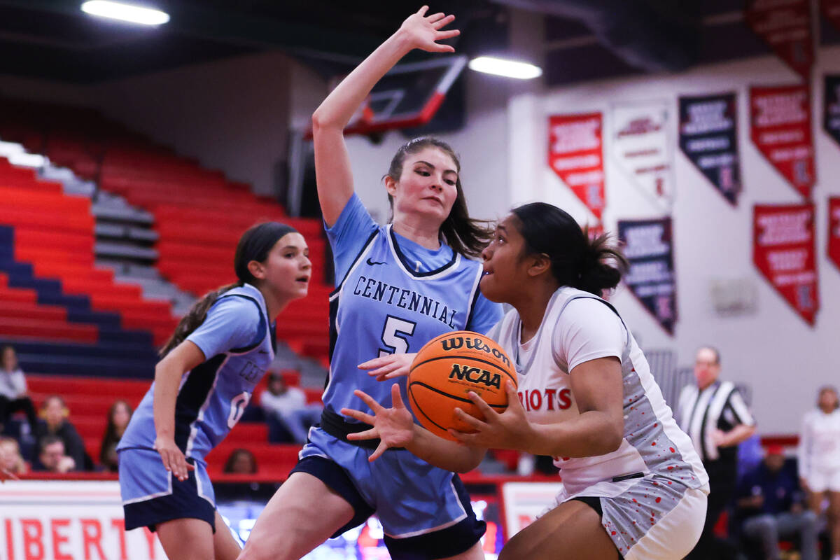 Liberty’s Aiyanna Eteuini (13) rushes to the net while Centennial’s Trysta Barret ...