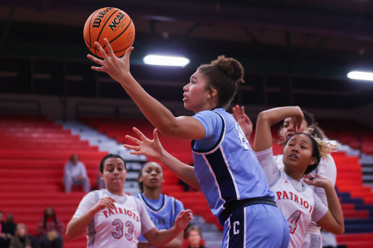 Centennial’s Nation Williams (24) goes in for a layup during a basketball game between L ...