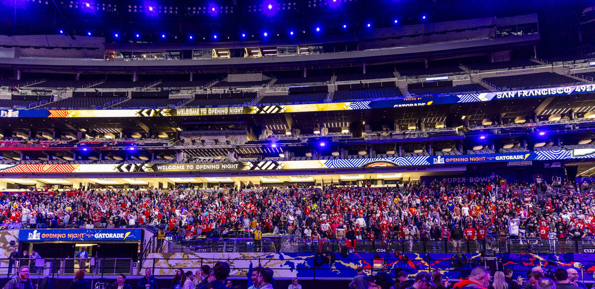 Fans stand and cheer by request of the Blue Man Group during the Super Bowl Opening Night celeb ...