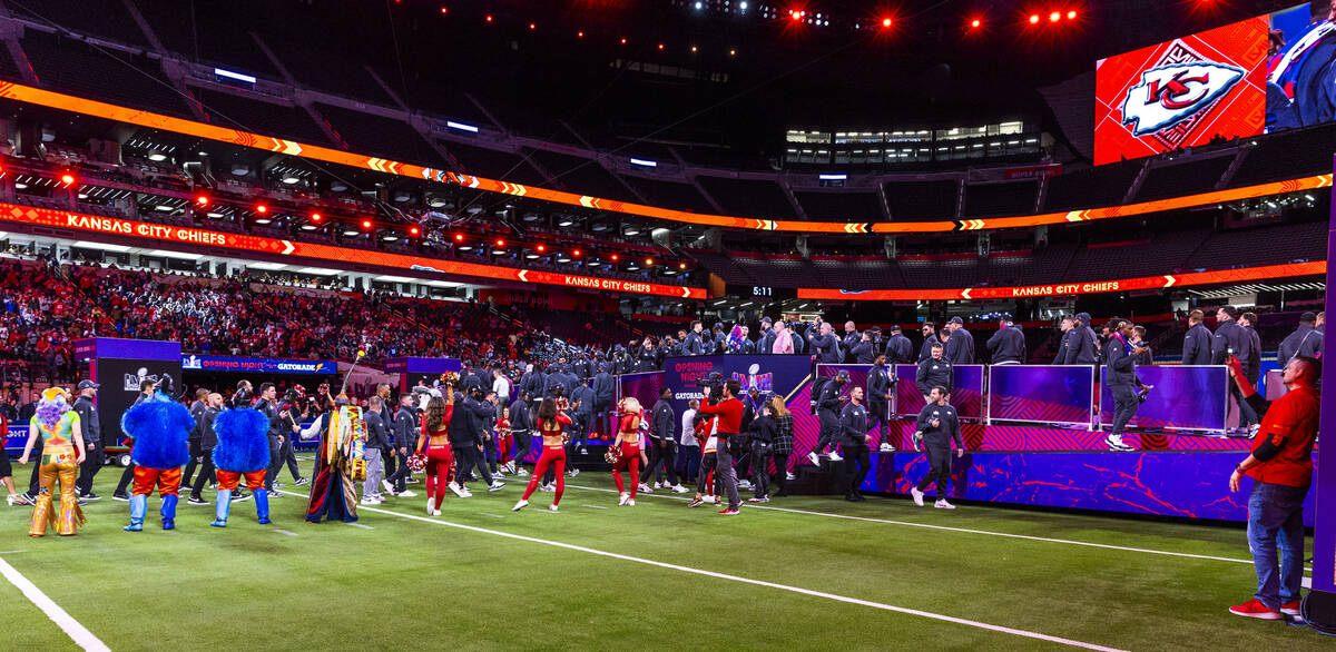 Kansas City Chiefs players and coaches stand before the crowd on the field during the Super Bow ...