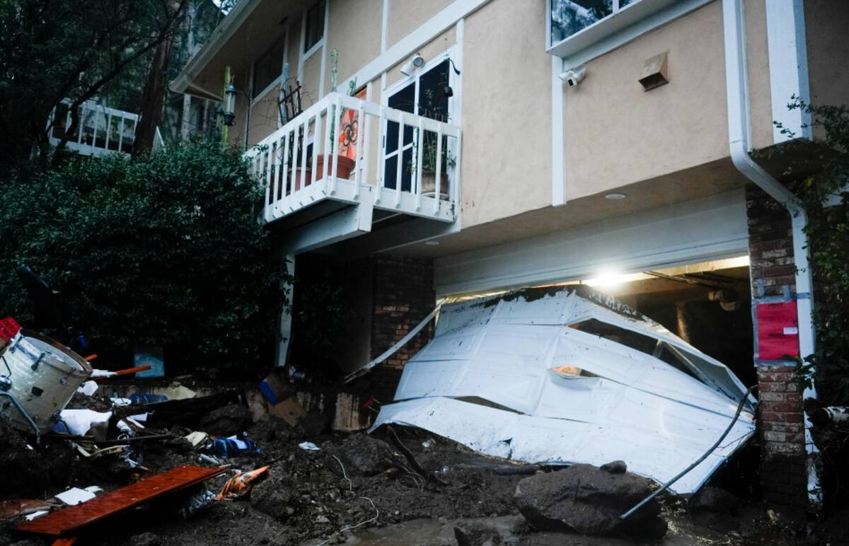 A garage door is damaged by a storm on a home, Monday, Feb. 5, 2024, in Studio City, Calif. (AP ...