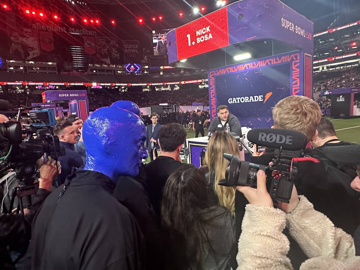 Members of the Blue Man Group are shown observing the 49ers' Nick Bosa during the Super Bowl Op ...
