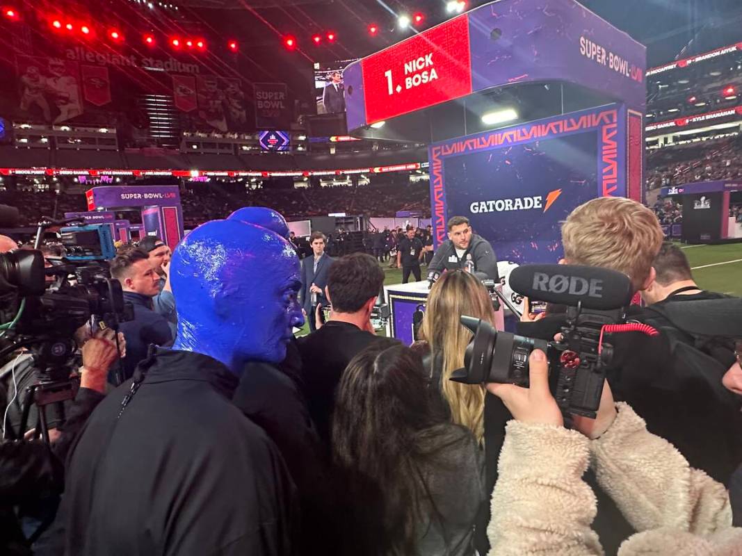 Members of the Blue Man Group are shown observing the 49ers' Nick Bosa during the Super Bowl Op ...