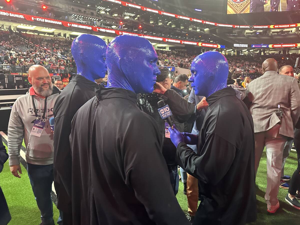 Members of the Blue Man Group are shown being interviewed during the Super Bowl Opening Night c ...
