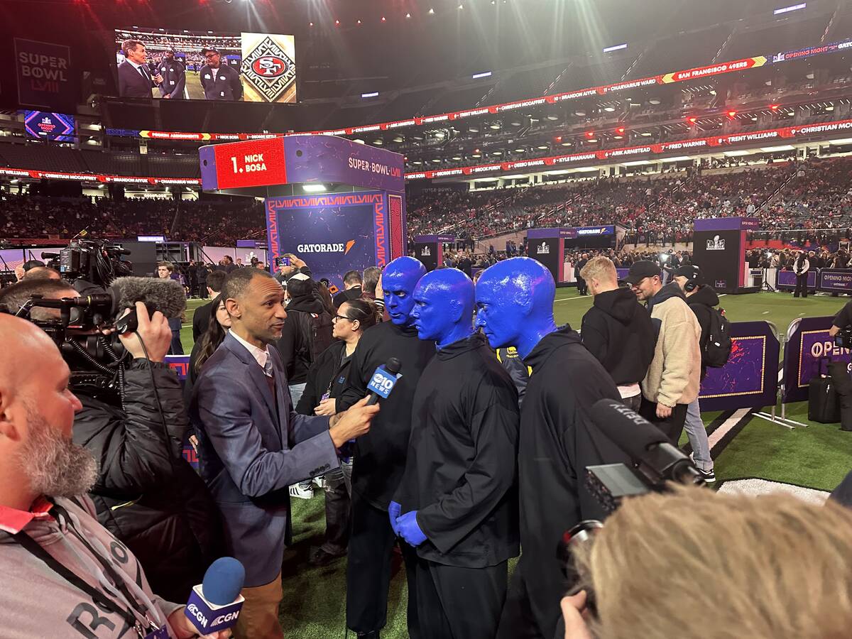 Members of the Blue Man Group are shown being interviewed during the Super Bowl Opening Night c ...