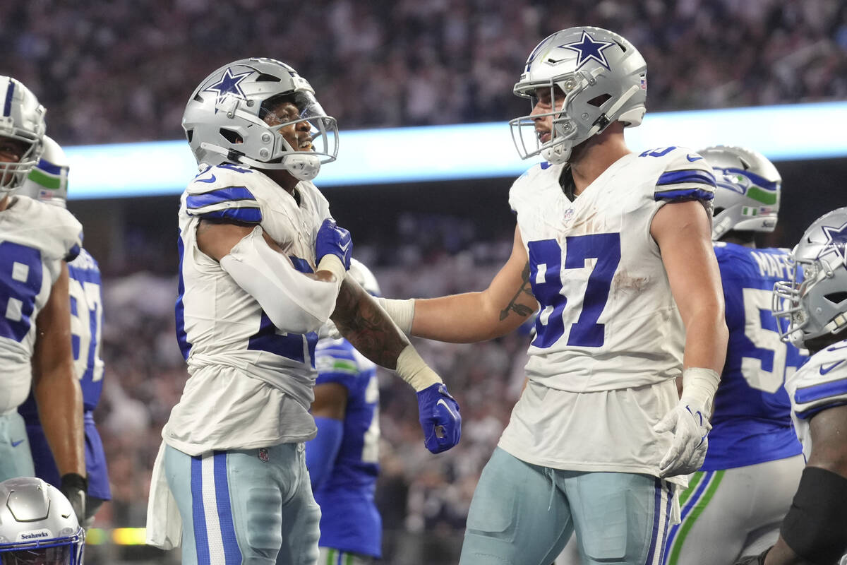 Dallas Cowboys running back Tony Pollard (20) pounds his chest after his rushing touchdown as h ...