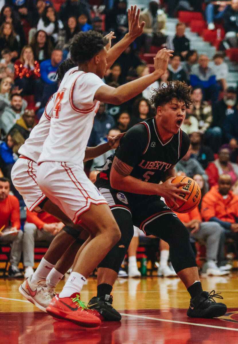 Liberty small forward Andre Porter (5) gets animated as he moves the ball towards the net durin ...