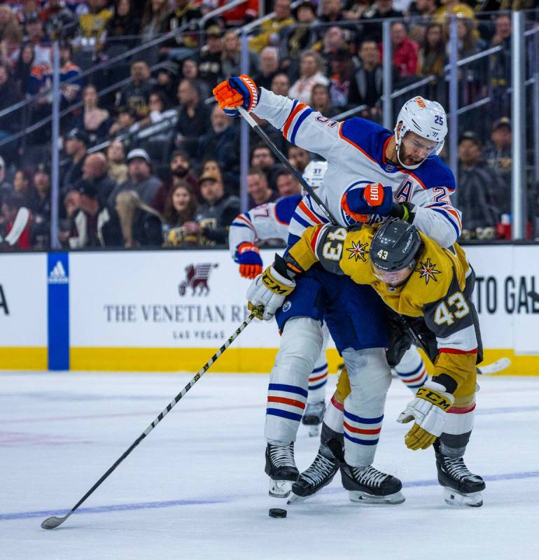 Golden Knights center Paul Cotter (43) is taken down on a drive by Edmonton Oilers defenseman D ...