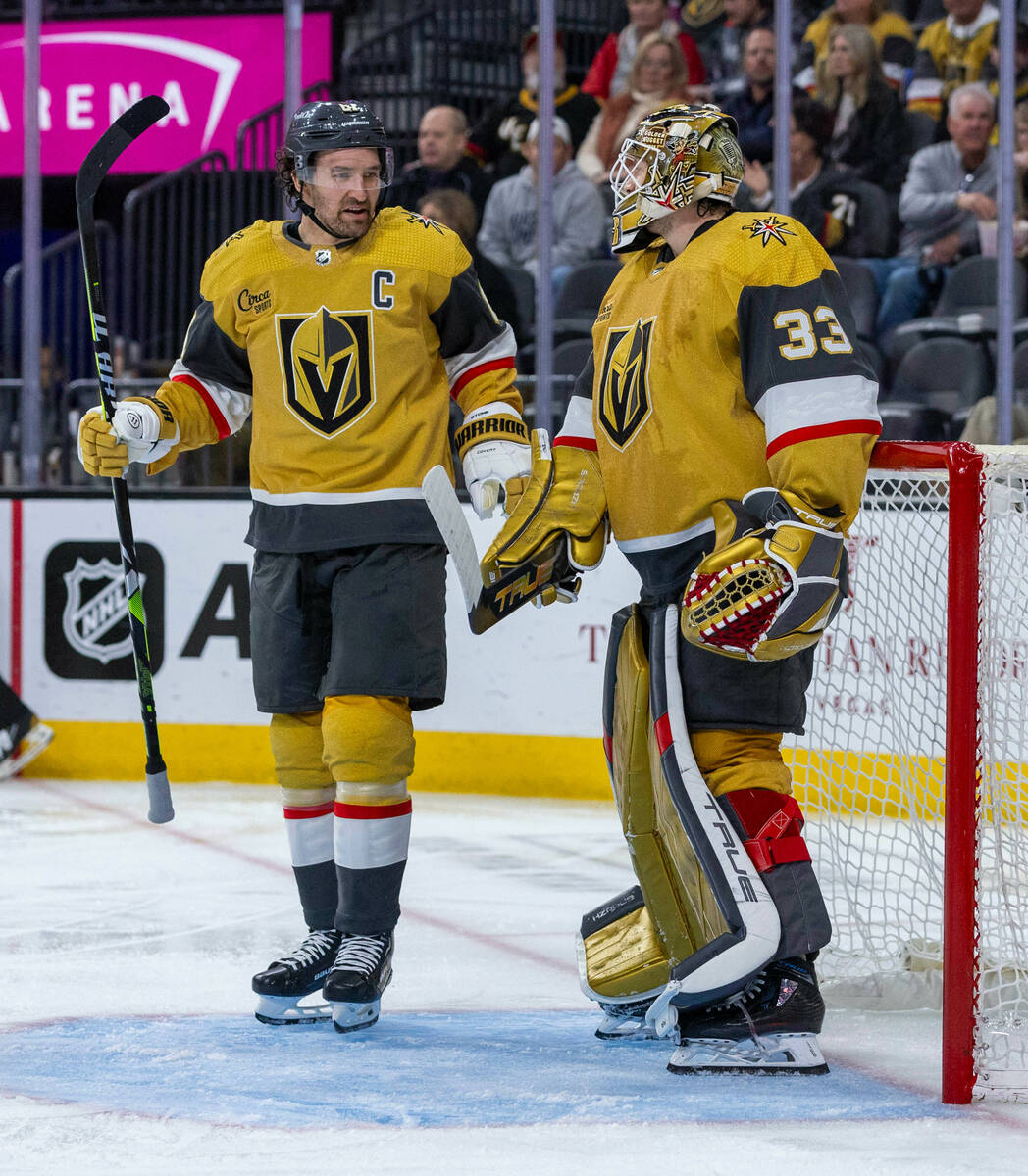 Golden Knights right wing Mark Stone (61) chats with goaltender Adin Hill (33) after an icing ...