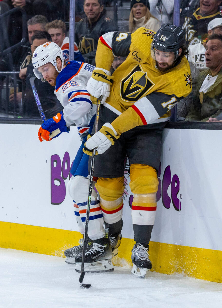 Golden Knights defenseman Nicolas Hague (14) takes control of the puck over Edmonton Oilers rig ...