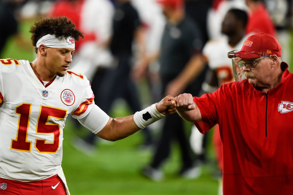 Kansas City Chiefs quarterback Patrick Mahomes (15) and head coach Andy Reid bump fists after a ...