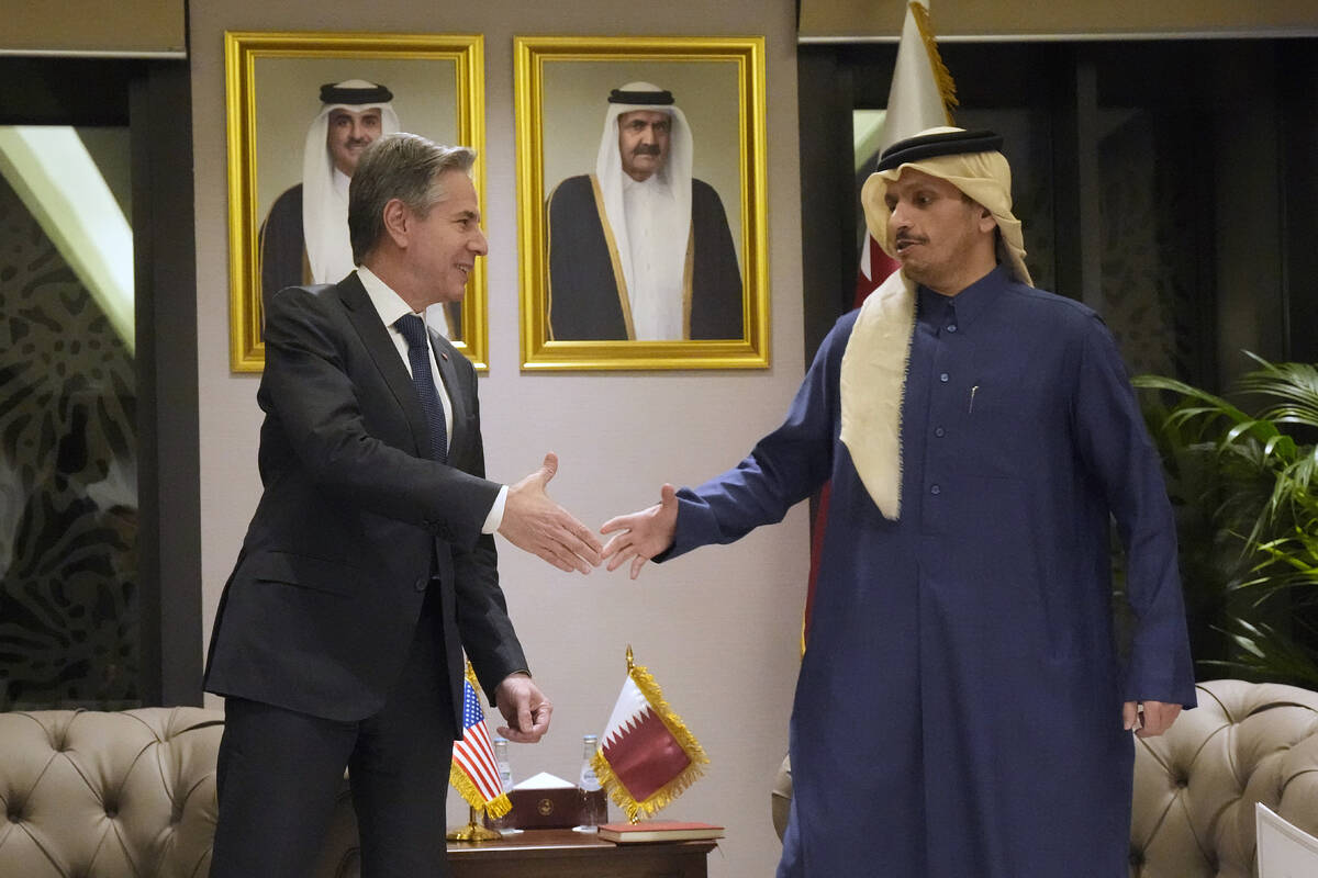 US Secretary of State Antony Blinken, left, shakes hands with Qatar's Prime Minister and Foreig ...