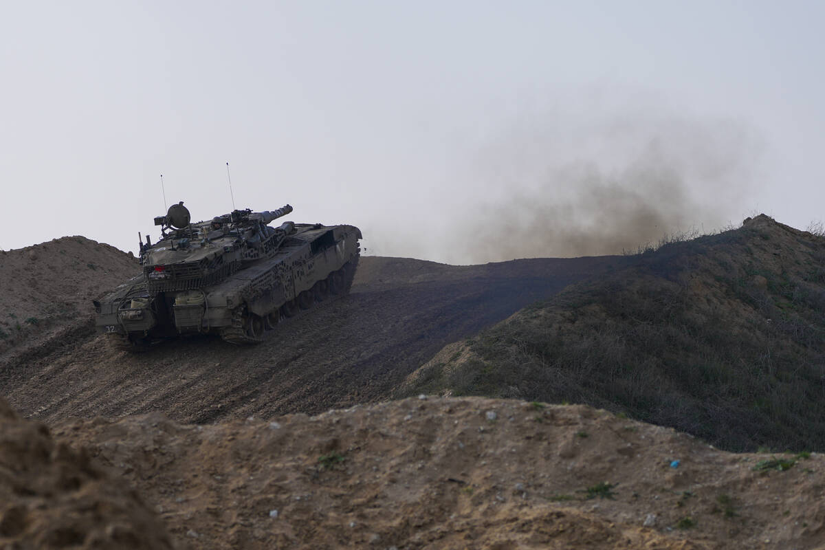 An Israeli tank in a position on the border with the Gaza Strip, as seen in southern Israel, Tu ...