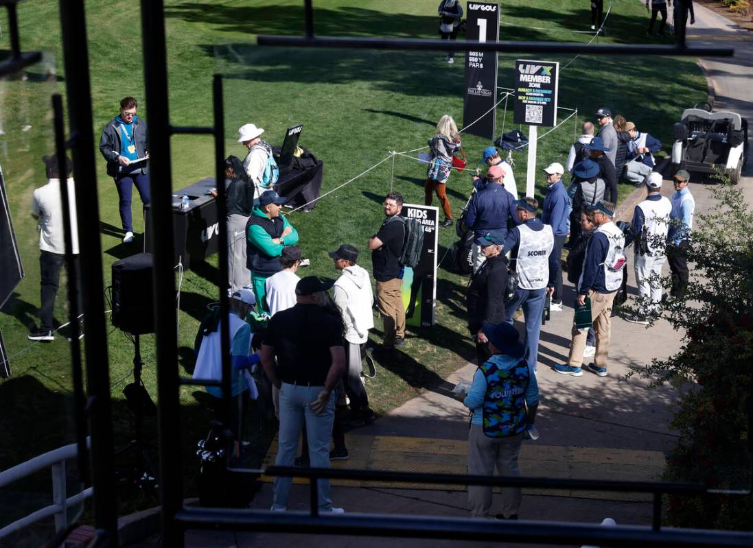 Players and their caddies gather at Las Vegas Country Club during LIV Golf Las Vegas Pro-Am tou ...