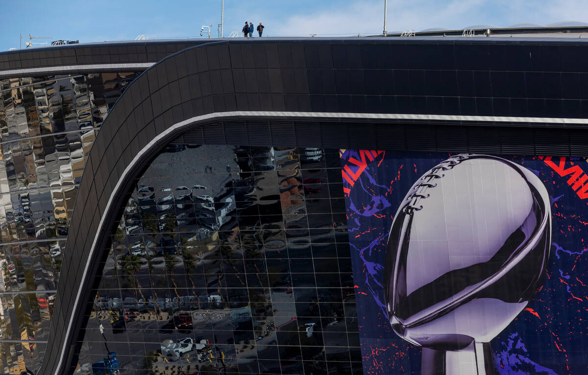 Crew members stand atop Allegiant Stadium as Super Bowl preparations continue on Wednesday, Jan ...