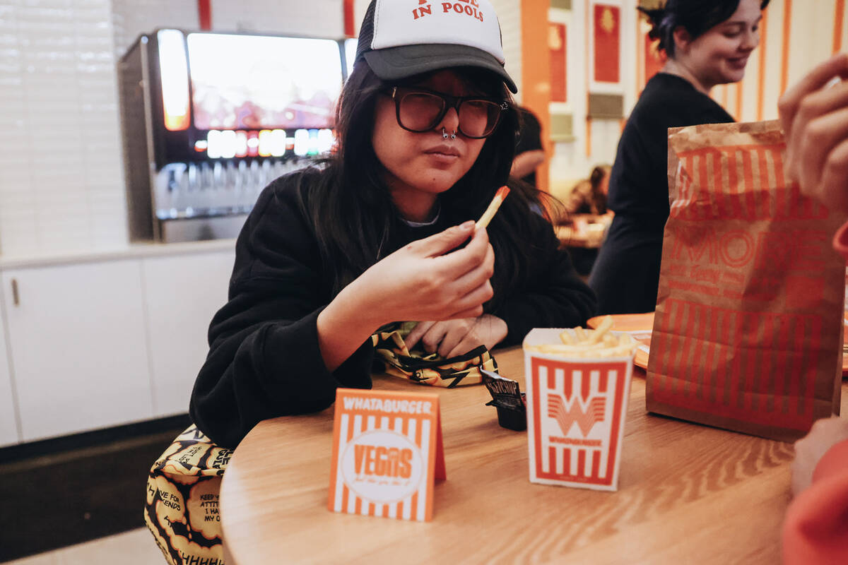 Anna L., a tourist from Dallas, Texas, eats a fry at Whataburger on Wednesday, Feb. 7, 2024, in ...