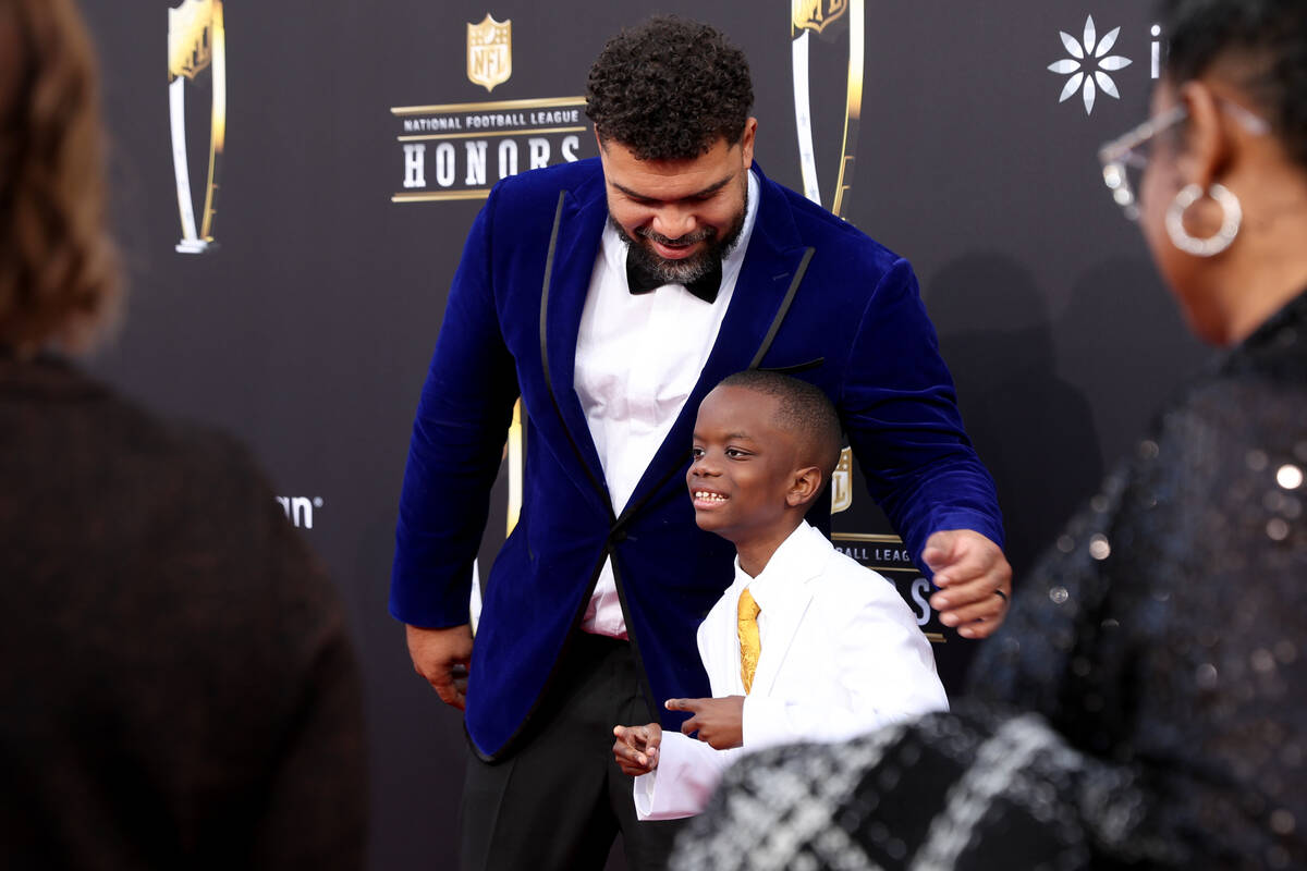 Jeremiah Fennell, 11, of Las Vegas, poses on the red carpet with Pittsburgh Steelers defensive ...