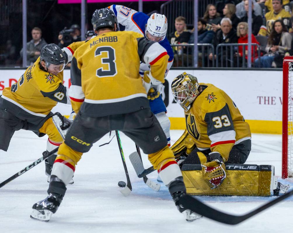 Golden Knights goaltender Adin Hill (33) defects a shot from Edmonton Oilers left wing Warren F ...