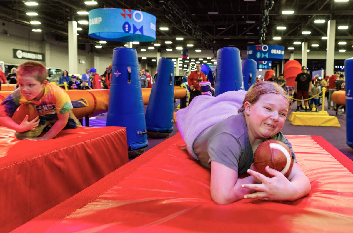 Gwen Clawson 9, of Puyallup, WA., dives onto a mat after navigating tackle dummies on a small o ...