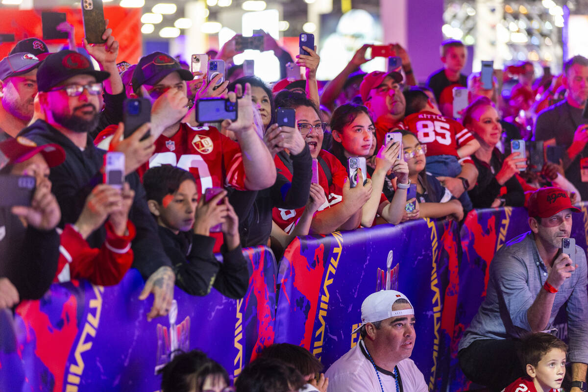 Fans enjoy seeing NFL great Jerry Rice carry in the Lombardi Trophy for the start of the Super ...