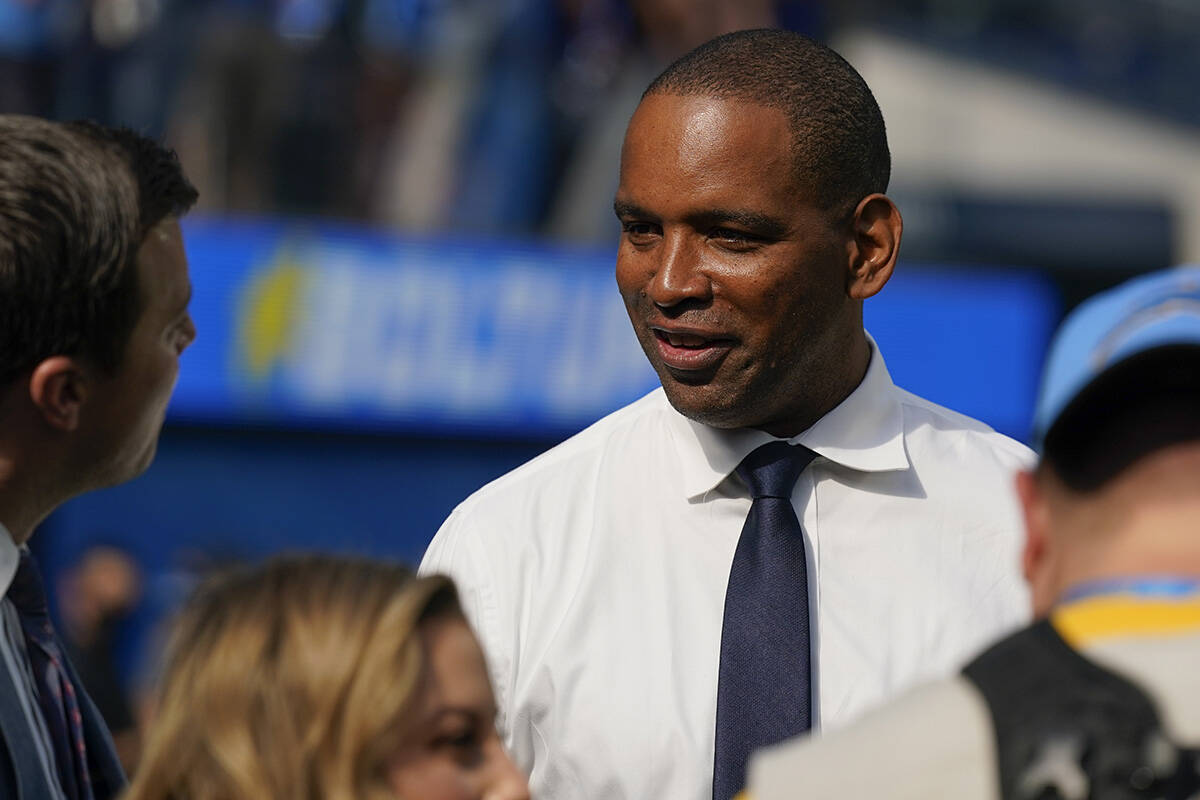 JoJo Wooden, director of player personnel for the Los Angeles Chargers, stands on the field as ...