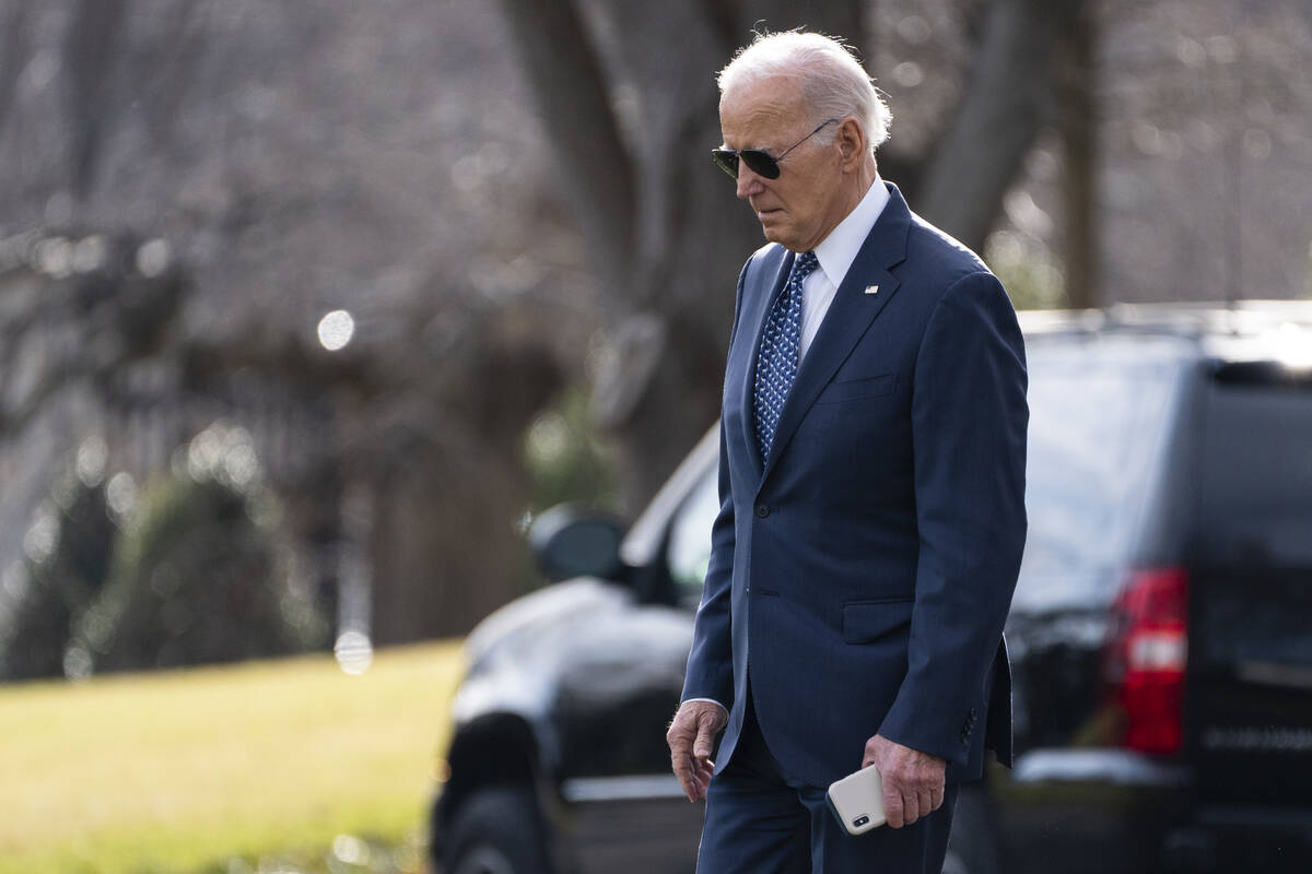 President Joe Biden walks to board Marine One on the South Lawn of the White House, Thursday, F ...