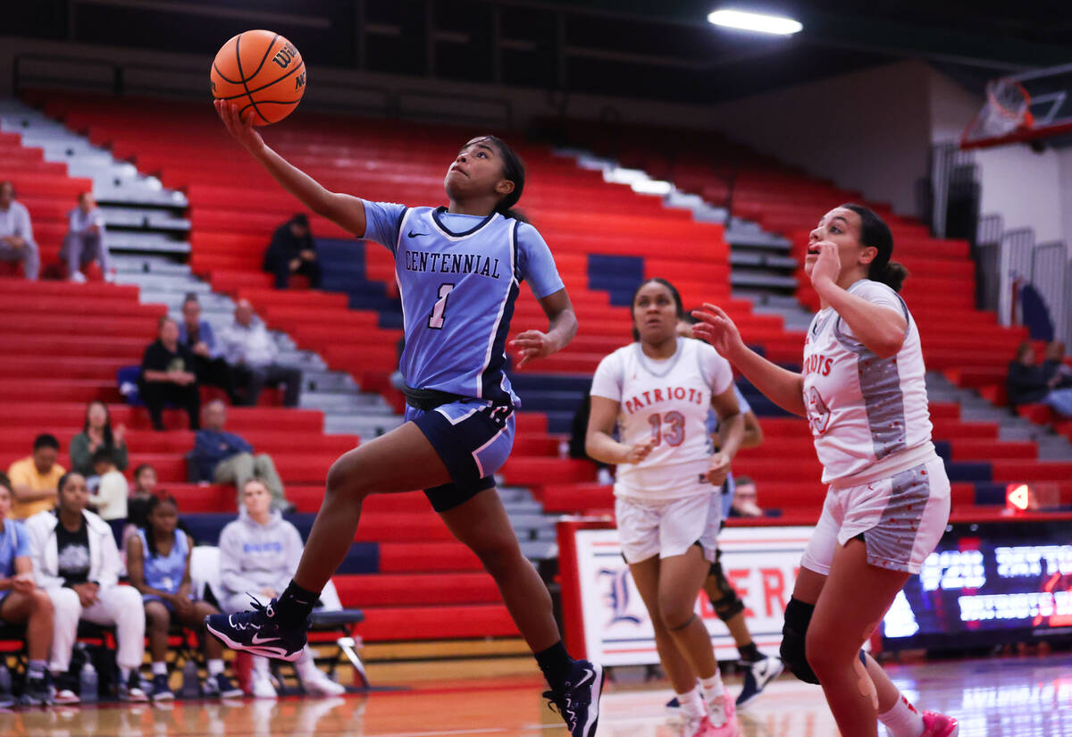 Centennial’s Azaia Tatum (1) goes in for a layup during a basketball game between Libert ...