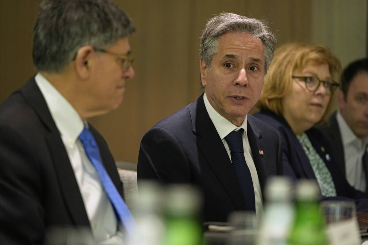 U.S. Secretary of State Antony Blinken, center, sits across the table as he meets with former I ...