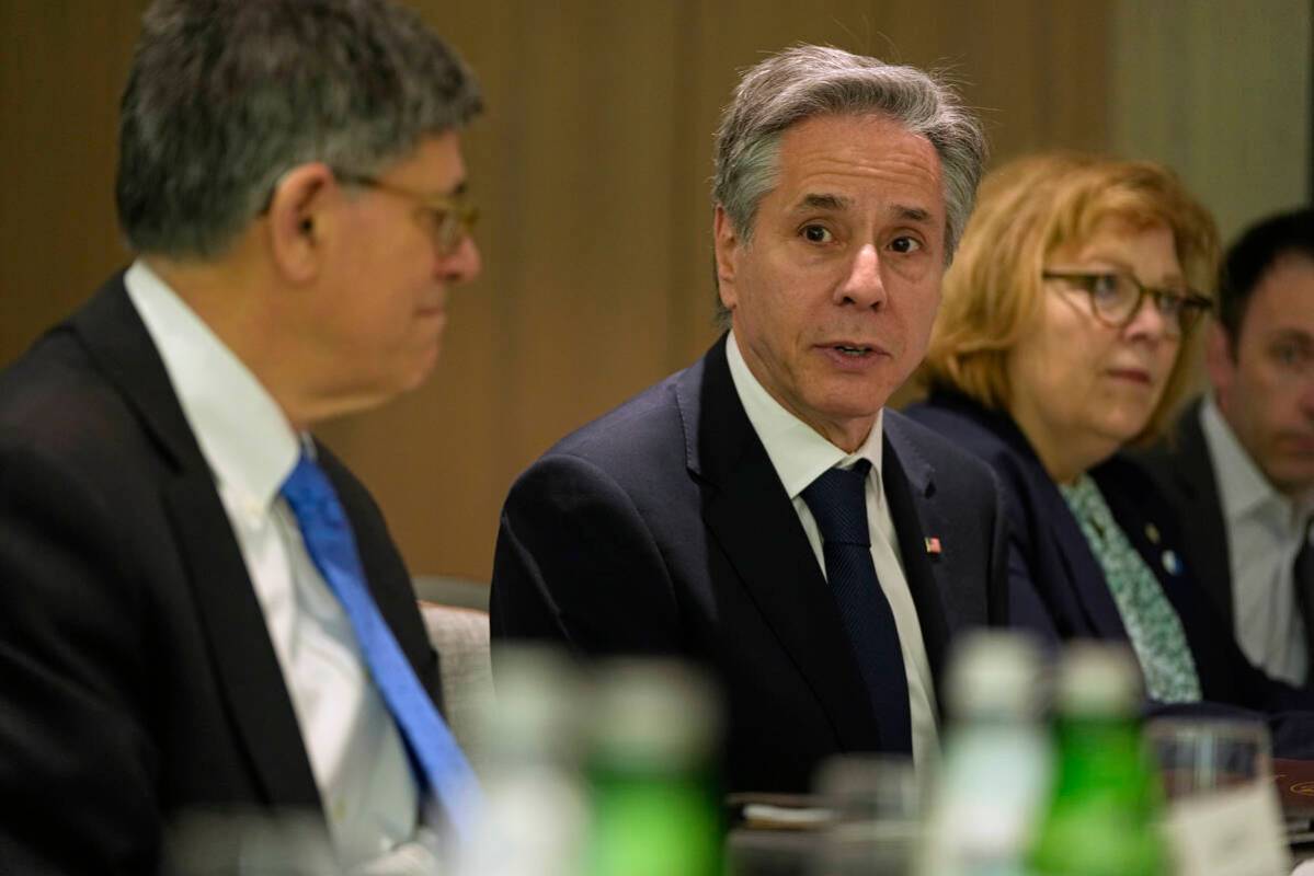 U.S. Secretary of State Antony Blinken, center, sits across the table as he meets with former I ...