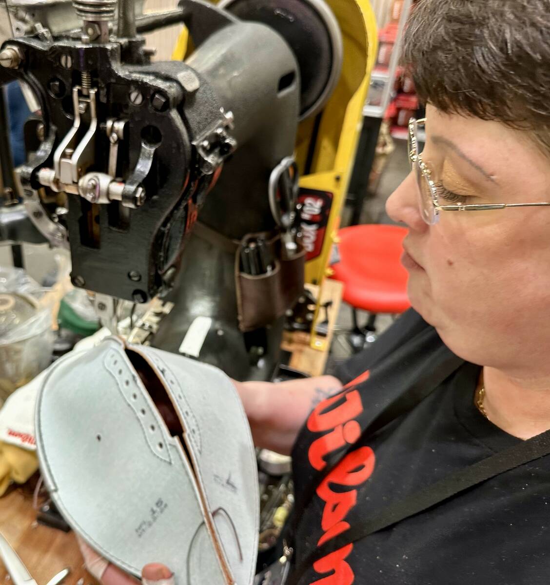 Ashley Lamb, 36, who works at the Wilson Football Factory in Ada, Ohio, demonstrates how she se ...