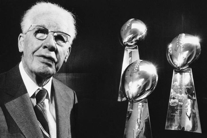 Art Rooney, Sr., owner of the Pittsburgh Steelers poses with his team's three Super Bowl Trophi ...