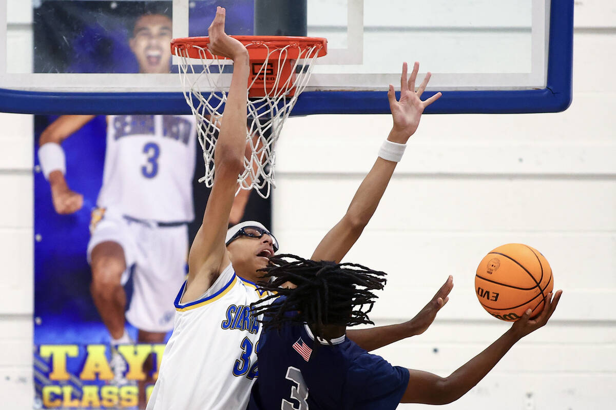 Sierra Vista center Xavion Staton (32) denies a shot by Shadow Ridge guard Brycen Nickerson (3) ...