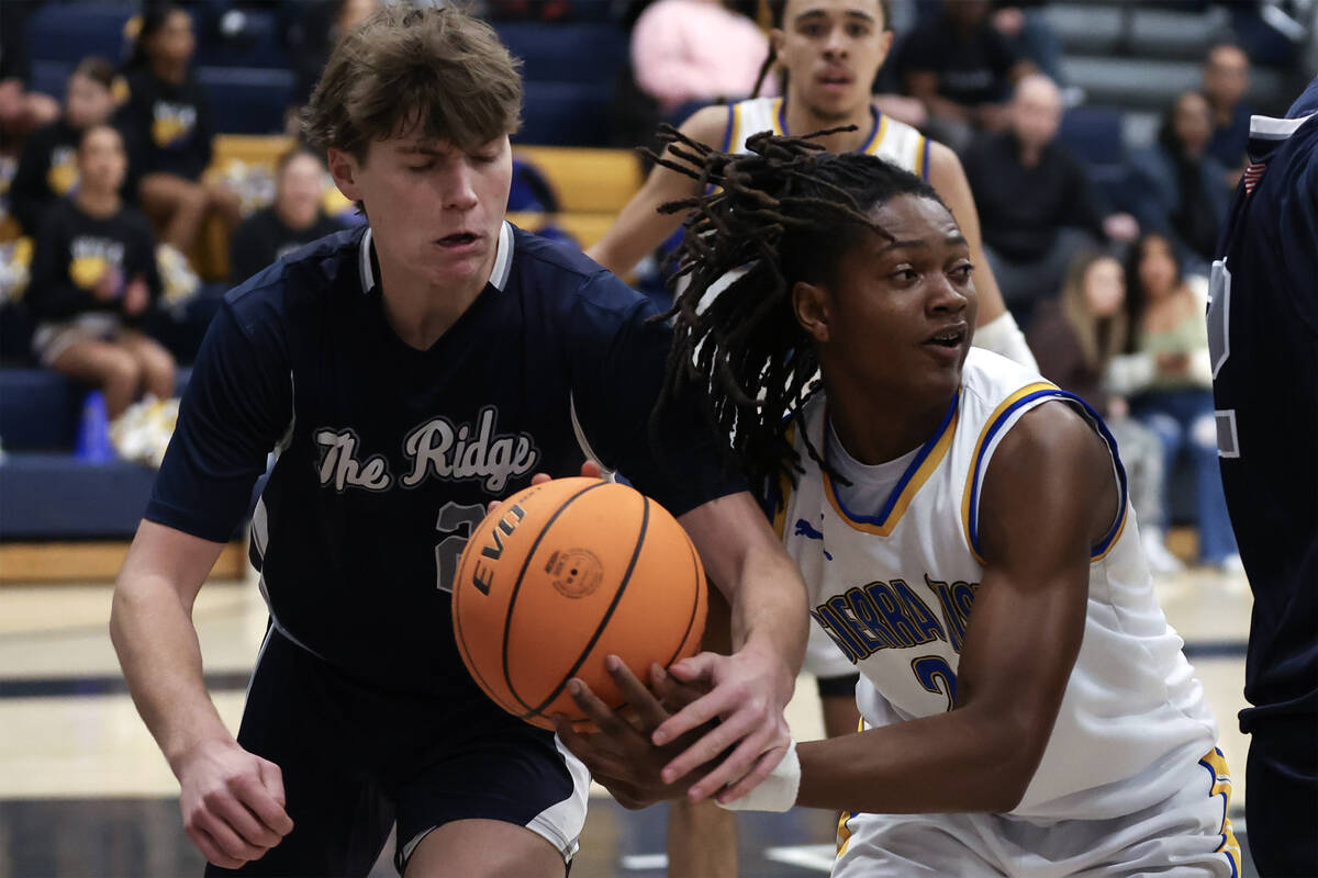 Shadow Ridge guard Brock Morrow (24) and Sierra Vista forward Darius Ruffin (20) battle for the ...