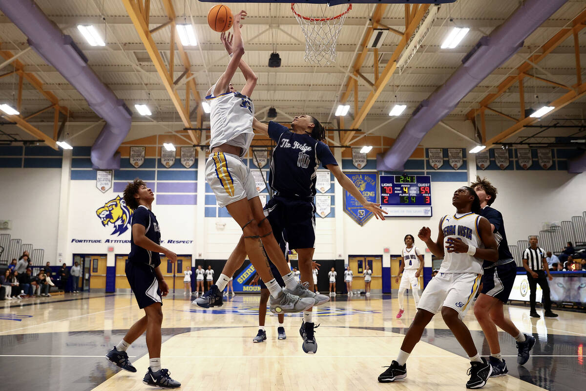 Sierra Vista center Xavion Staton (32) shoots against Shadow Ridge forward Isaiah Trotter (10) ...