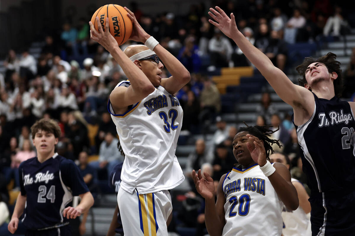 Sierra Vista center Xavion Staton (32) snags a rebound over Shadow Ridge forward Joseph Martins ...