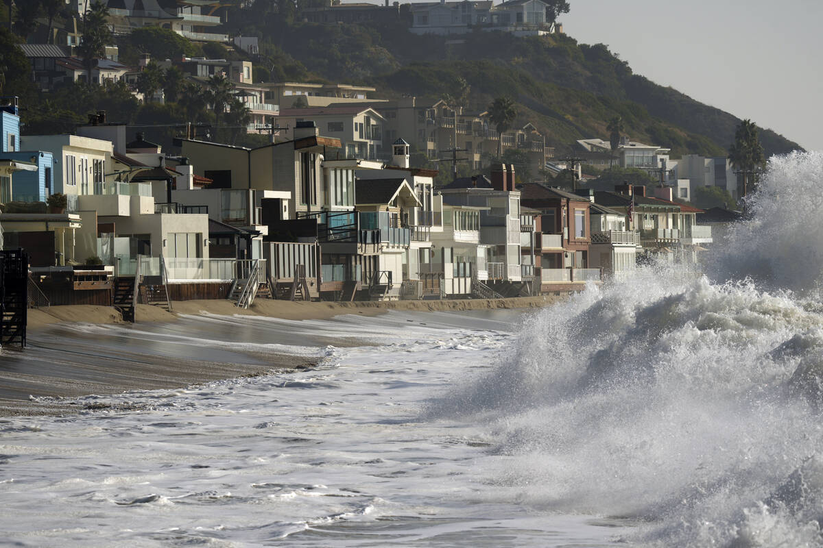 FILE - Waves break near beach homes in Malibu, Calif., on Dec. 28, 2023. An earthquake with a p ...