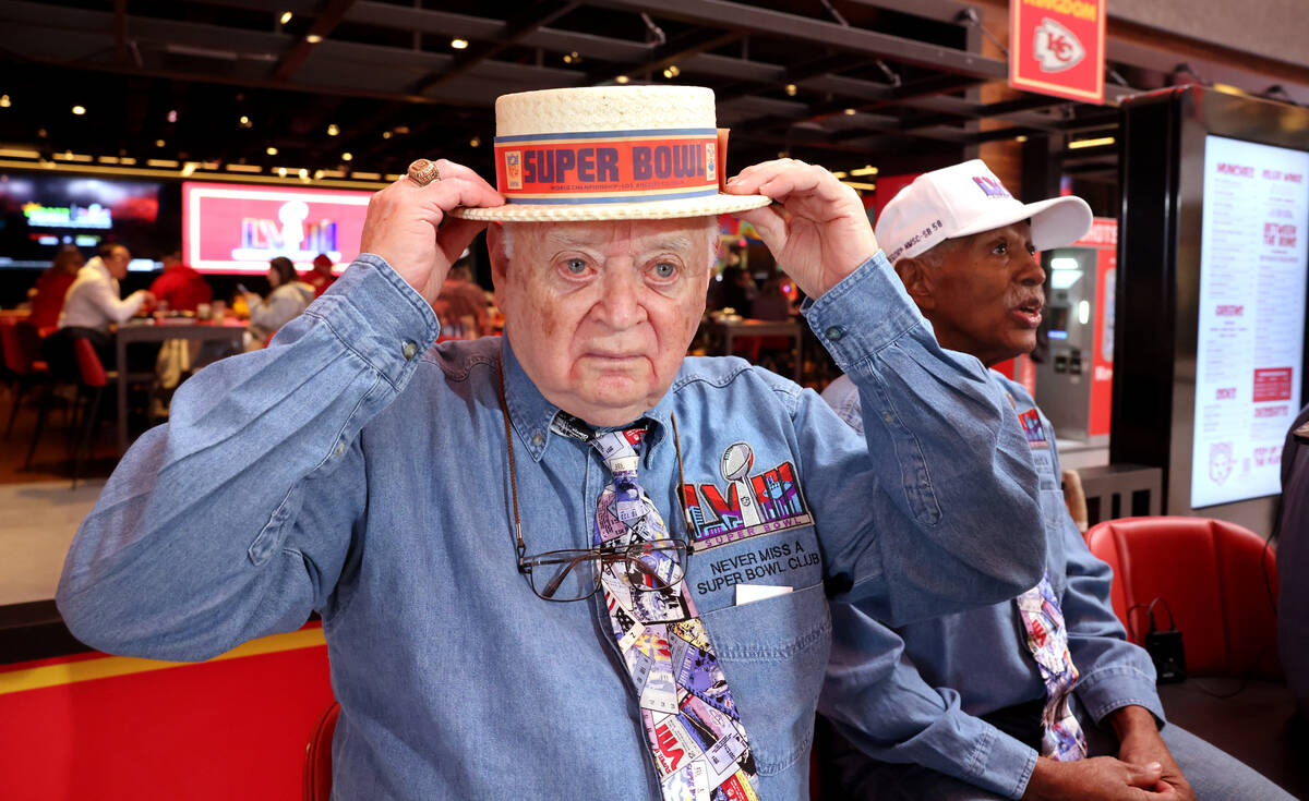 Don Crisman, 87, a members of the Never Miss a Super Bowl Club, dons a hat he wore at the first ...