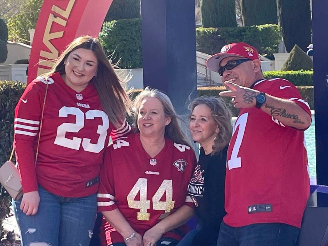 Samantha Gomez (left) poses in front of the Super Bowl photo backdrop near Caesars Palace on Sa ...