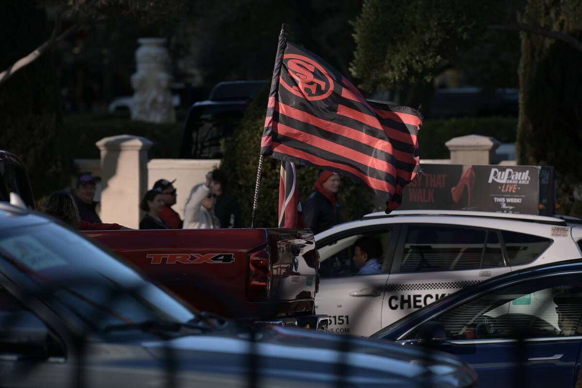 A truck carries a San Francisco 49ers flag on the Strip the day before Super Bowl LVIII Saturda ...