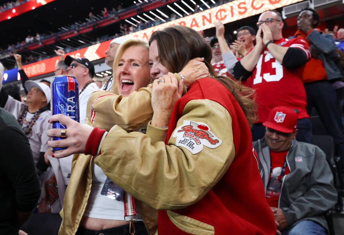 San Francisco 49ers fans hug during the first half of Super Bowl 58 against the Kansas City Chi ...