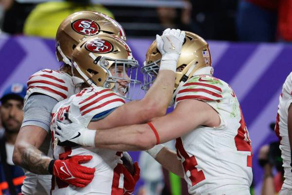 San Francisco 49ers running back Christian McCaffrey (23) is congratulated by San Francisco 49e ...