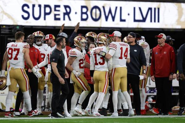 San Francisco 49ers quarterback Brock Purdy (13) is congratulated after their touchdown against ...