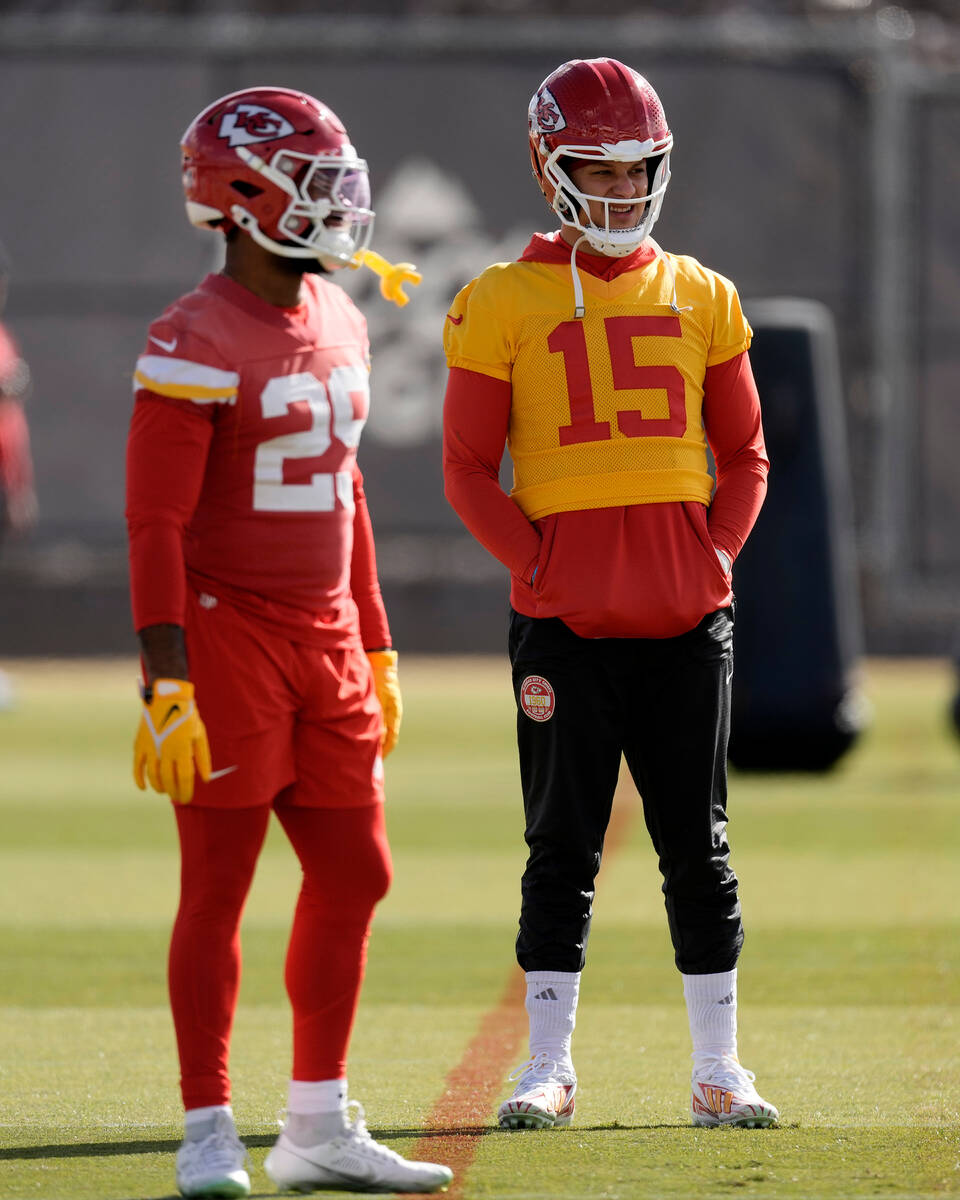 Kansas City Chiefs running back La'Mical Perine, left, and quarterback Patrick Mahomes (15) tal ...