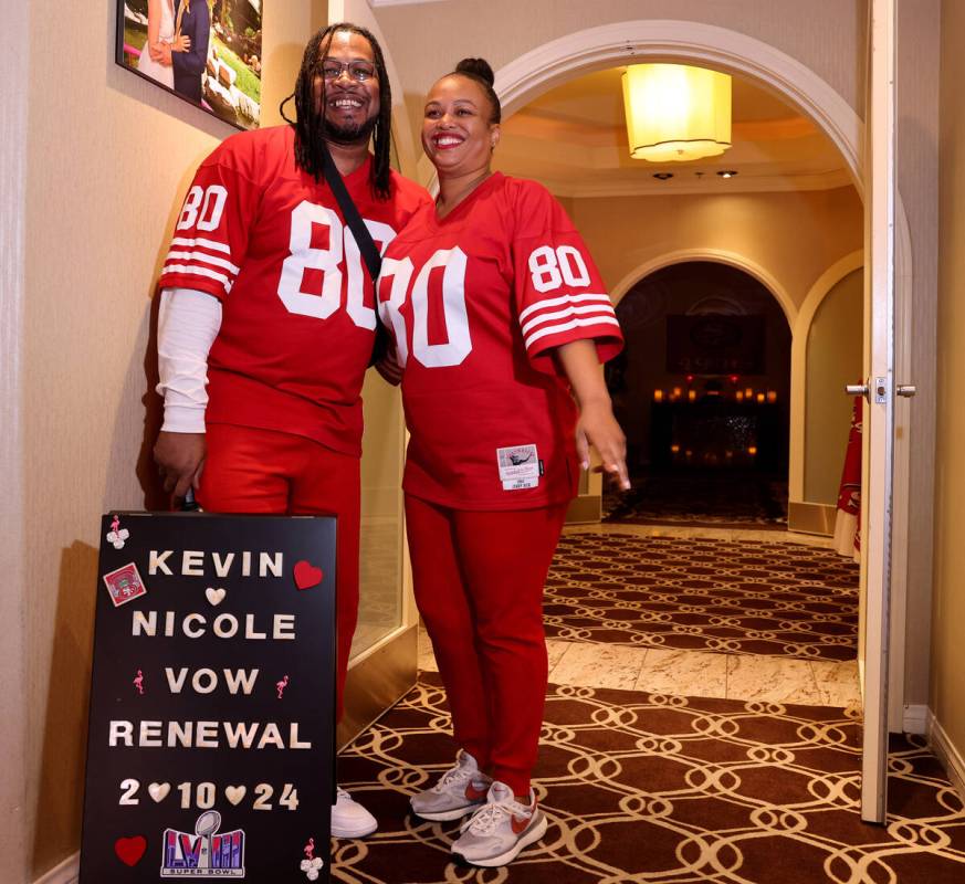 Nicole and Kevin Crockrom of Las Vegas pose with their sign before renewing their wedding vows ...