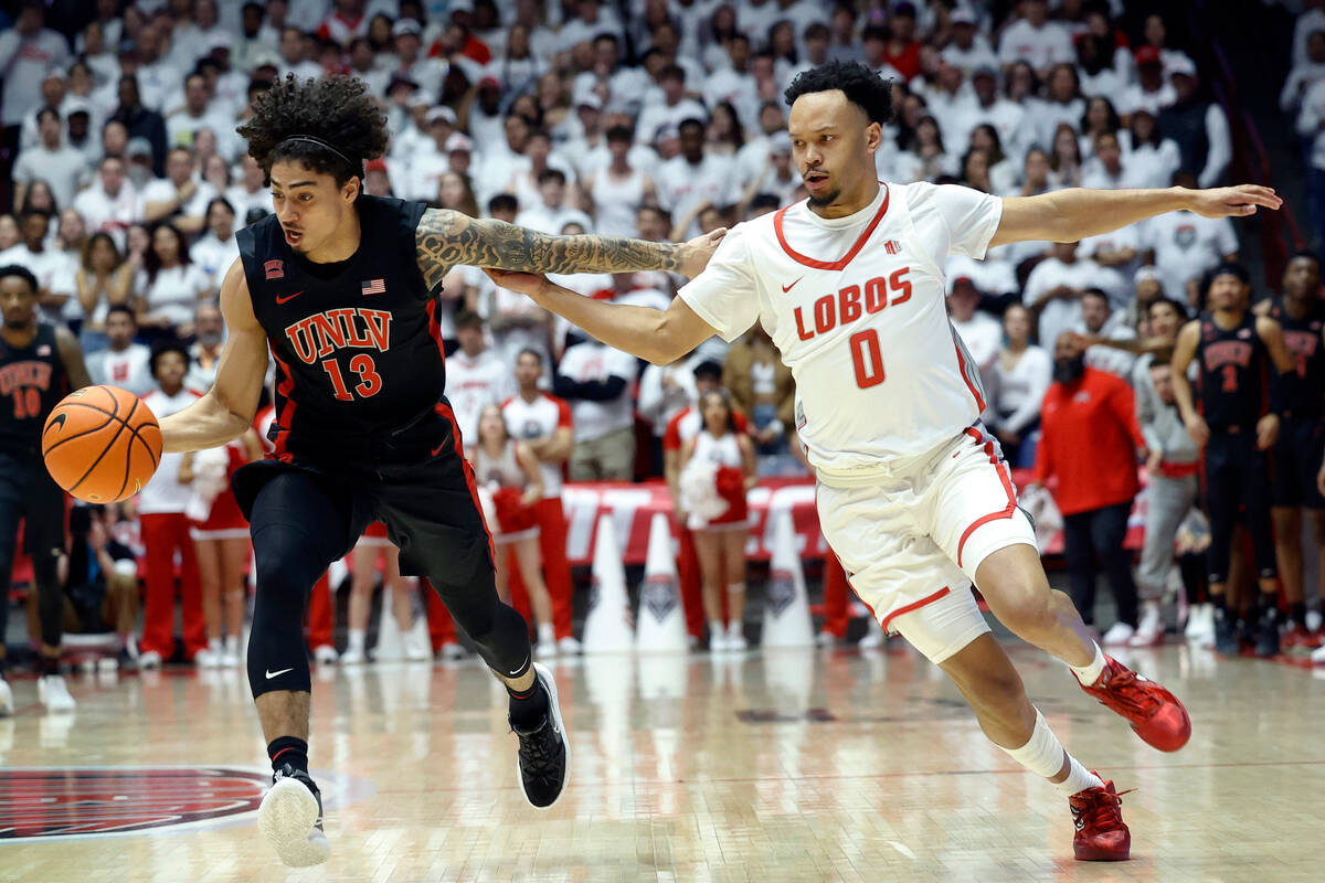 UNLV guard Brooklyn Hicks, left, and New Mexico guard Jamari Baker Jr. chase a loose ball durin ...